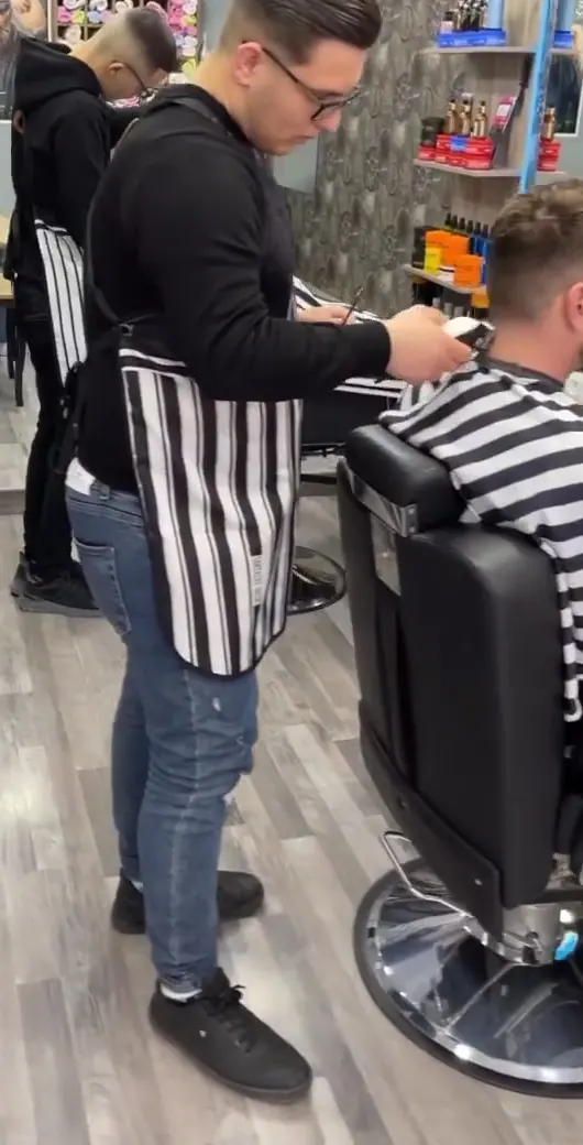 A Visi barber cutting a guest's hair