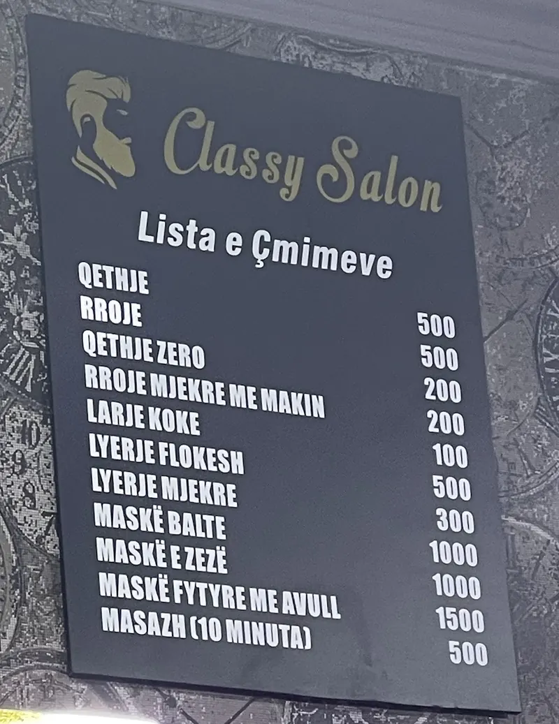 The printed price list of Barbershop Visi, Lista e Çmimeve, on the shop wall