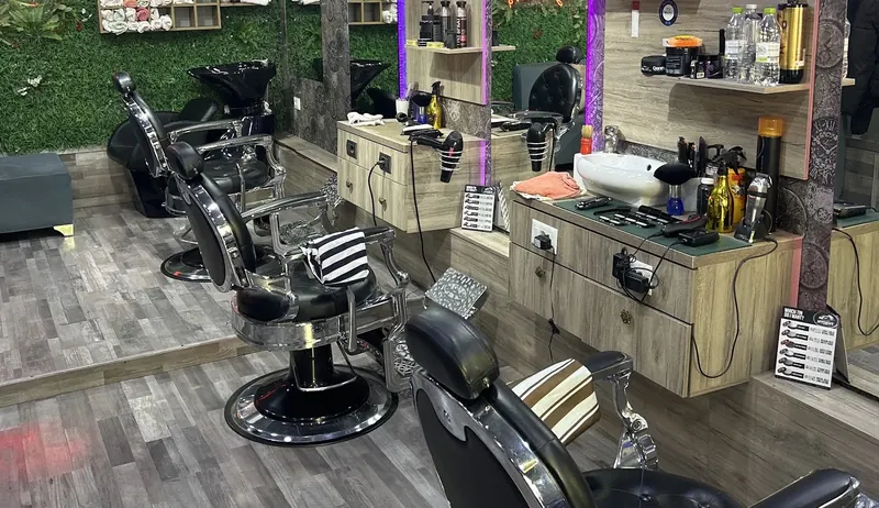 Inside Barbershop Visi: chrome barber chairs and the green wall